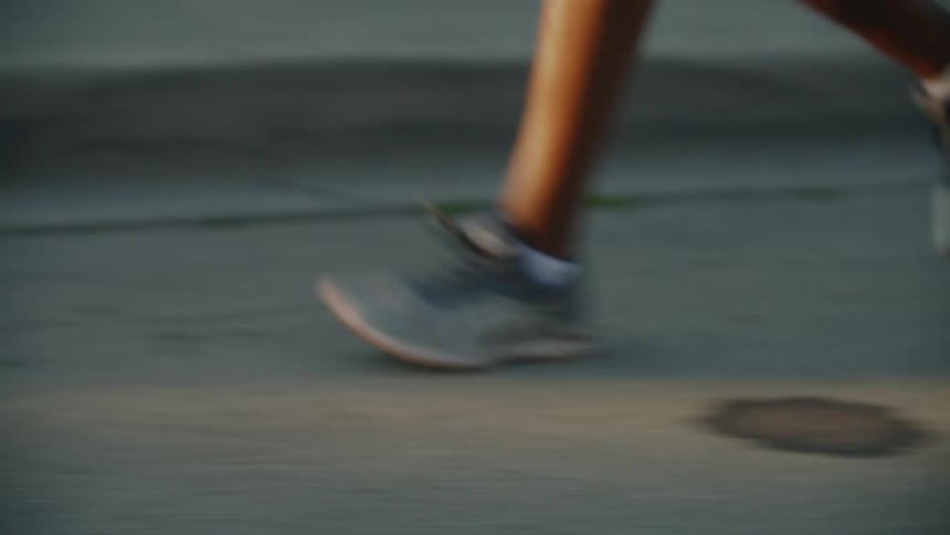A person runs along the road as they exercise