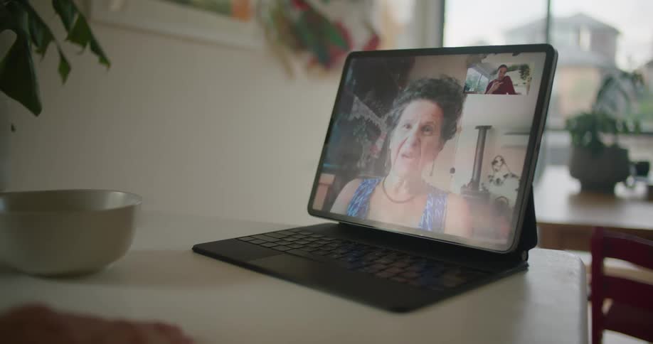 A person talking to someone on a tablet