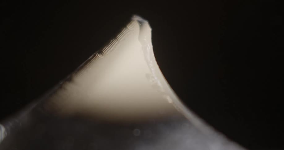 Light shines and flashes on a triangular piece of glass or ice