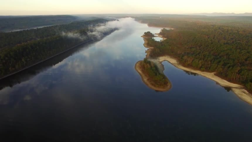Aerial view of a lake between two forests