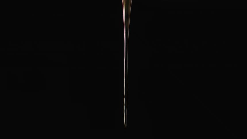 A gel dripping with a black background