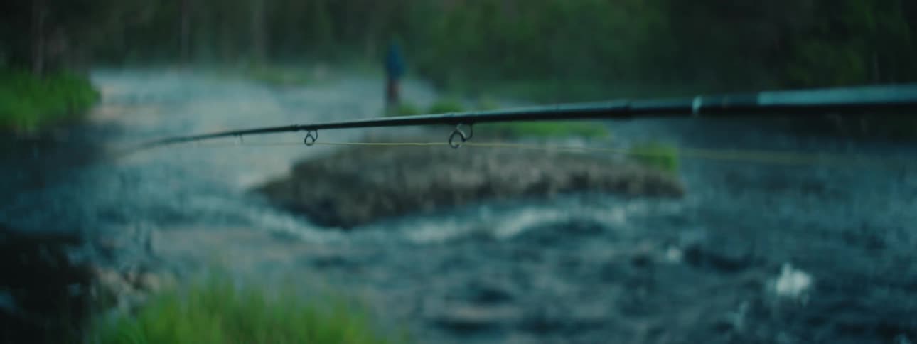 Man standing on a river in the forest fly flishing at morning