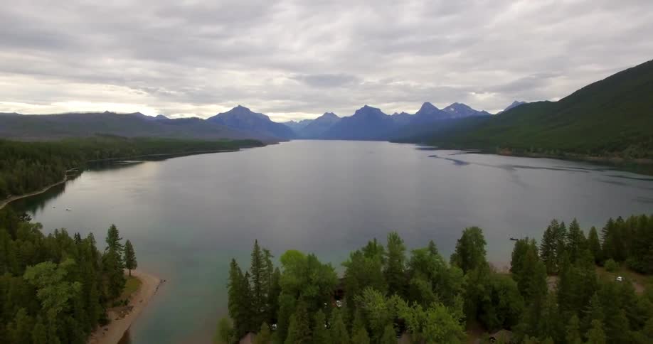 Trees surround a calm lake in the mountains