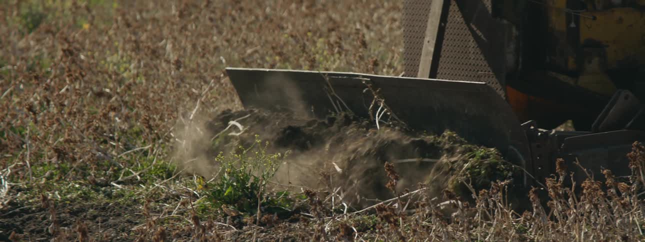 A person plowing land on a farm