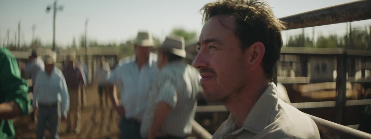 A group of people standing outdoors on a farm