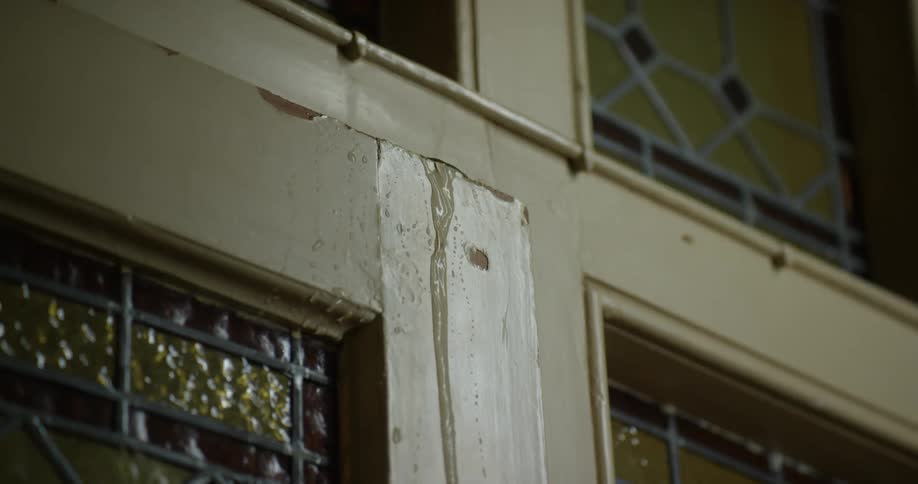 A room with a door with water dripping