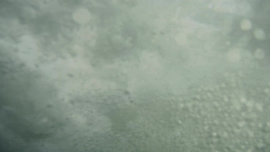 Waves crashing in water from underneath