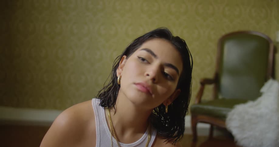 A portrait of a young woman sitting on a living room floor