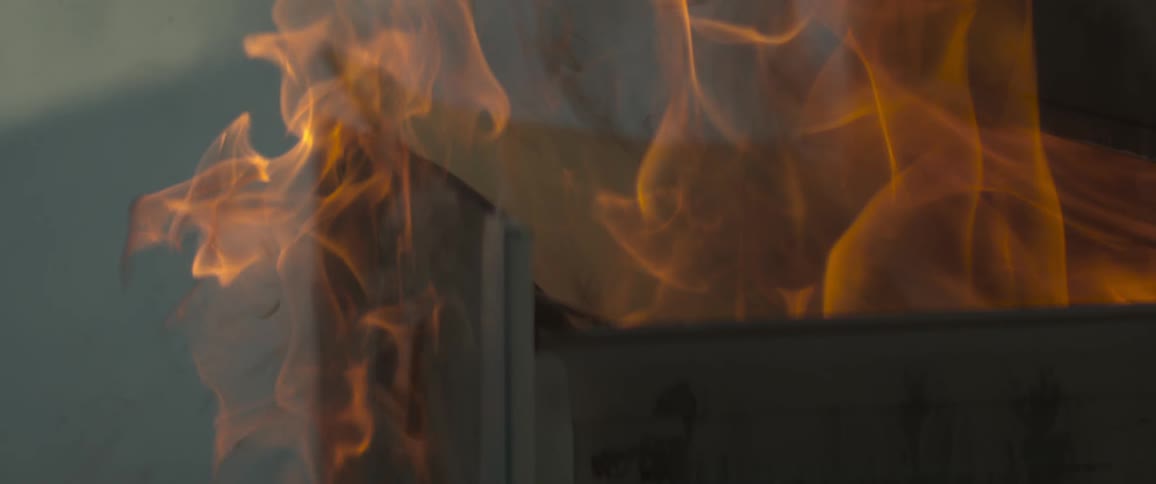 A cabinet is covered with flames