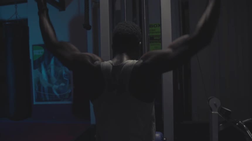 A man is working out with weights in a gym