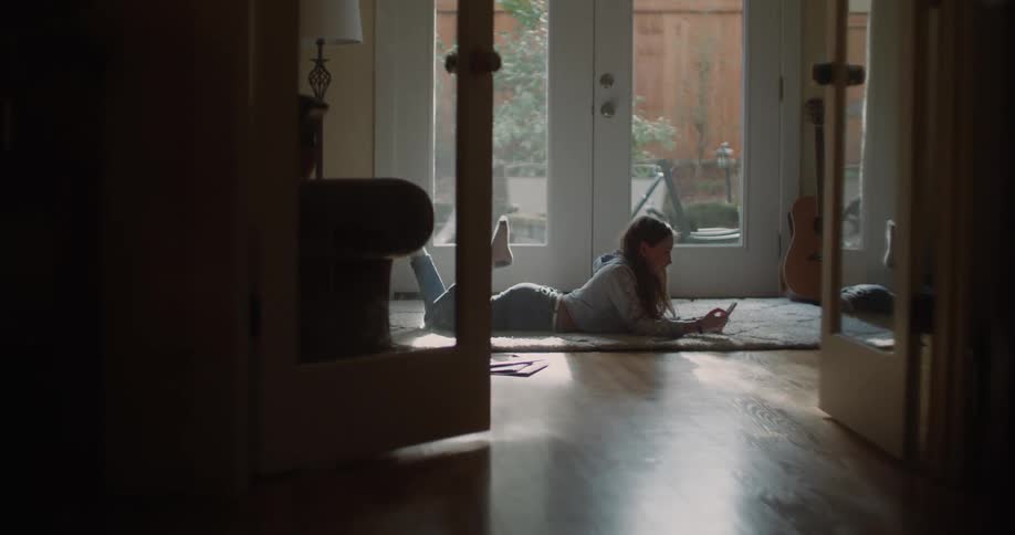 A woman laying on the floor relaxing in a house