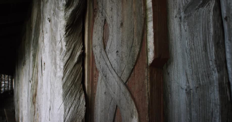 View of an animal carved into wood framing on a Viking village