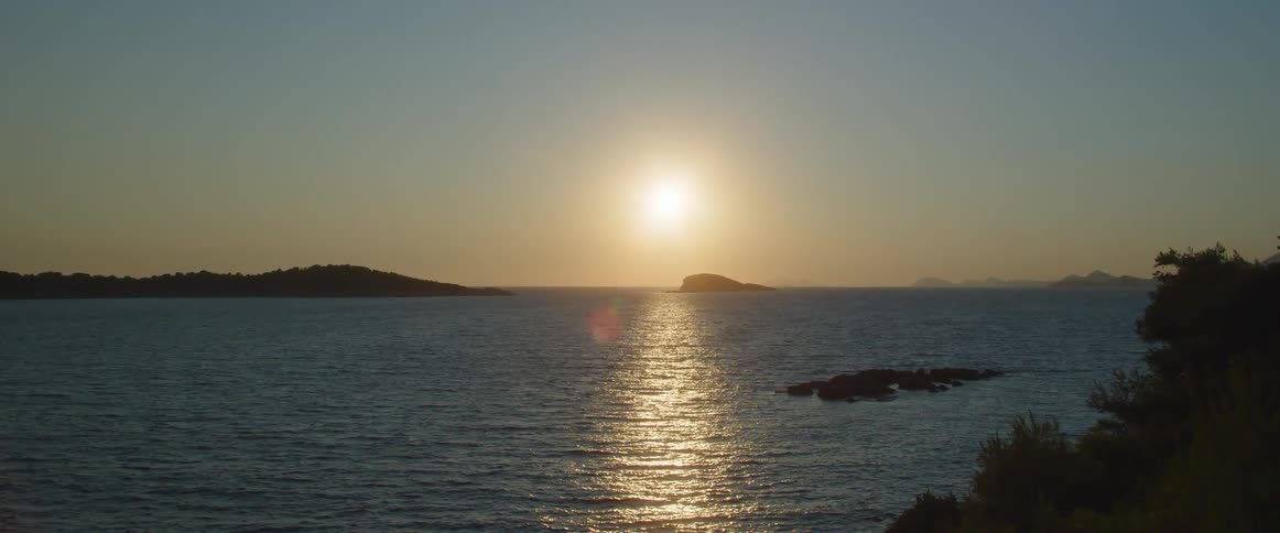 The sun rises over gentle waves in the sea