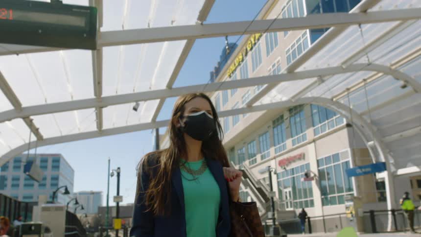 A woman walking into a public transit station