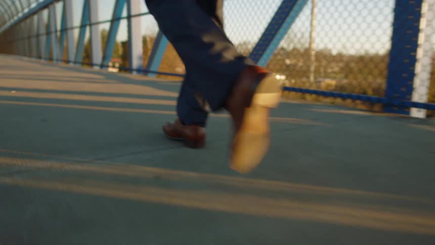 A person walks across an elevated walkway during the day