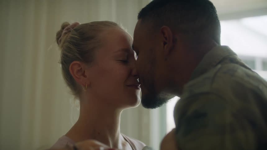 Family standing together with parents kissing