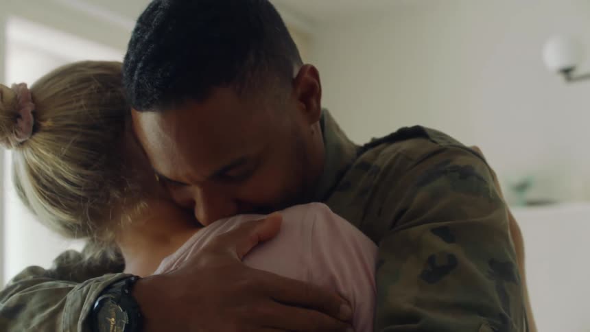 A man and woman kissing and hugging at home