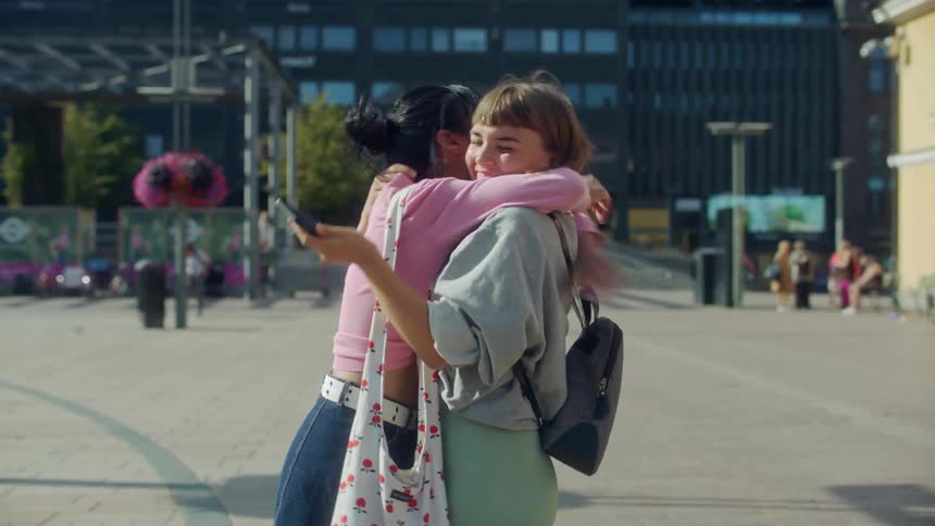 Two women hugging each other outdoors
