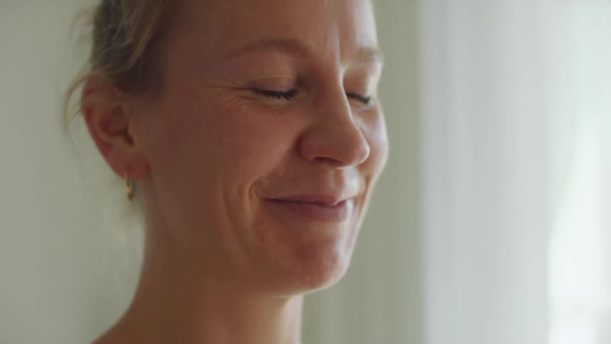 A woman smiling indoors