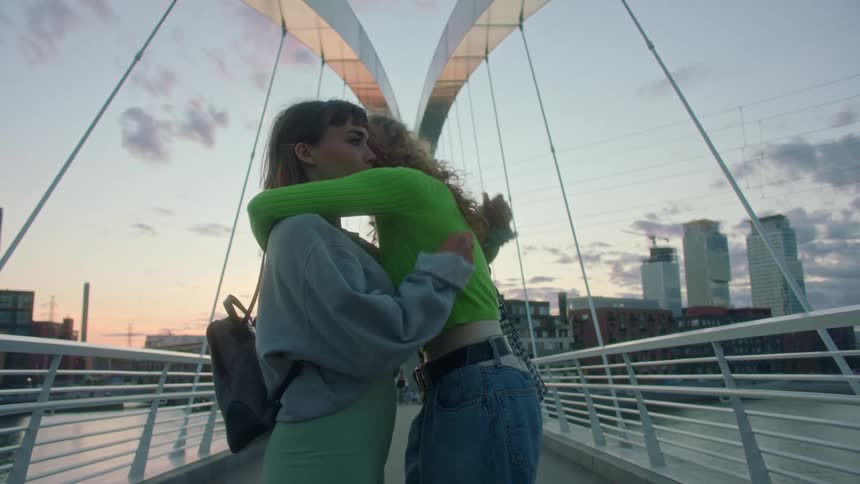 Two women hugging each other outdoors