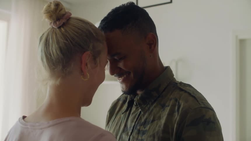 A man and woman are facing each other and smiling