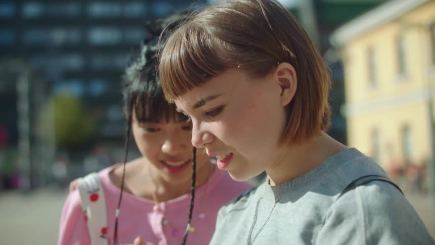 Two women that are friends talking outdoors