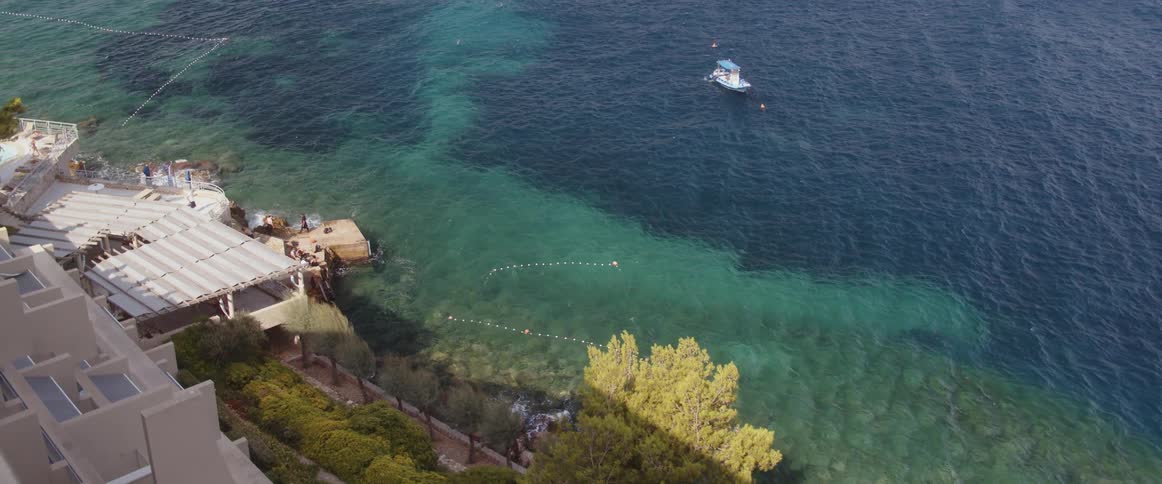 People hang out in a hot tub and play on a private beach at a home along the coast