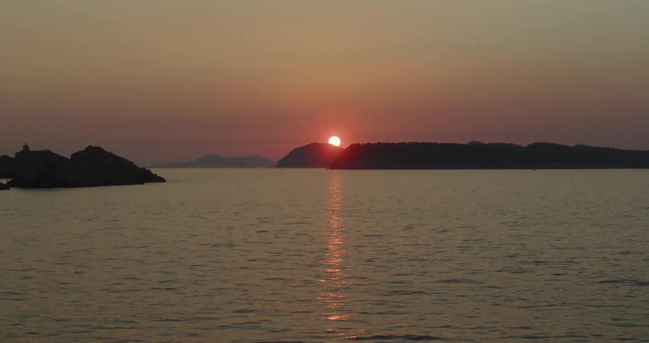 A view of the sun setting over rocks
