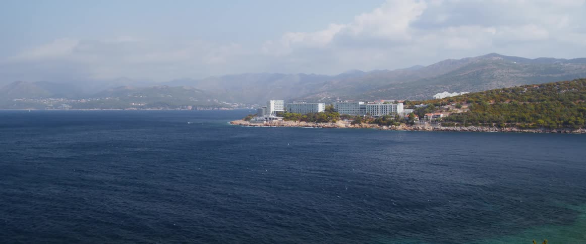 Skyscrapers sit along the beach of a city by the ocean