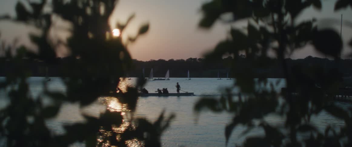 A group of people travel in the lake with a row boat