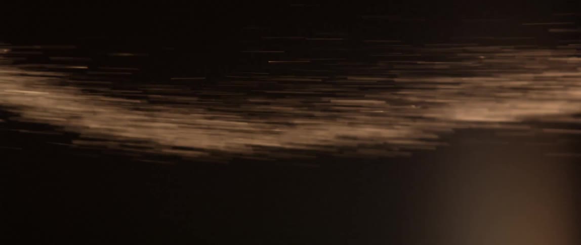 A swirl of sand moves to the right