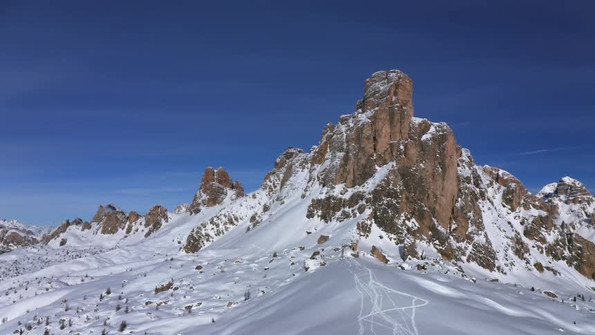 Snow covered mountains with peaks high in a blue sky