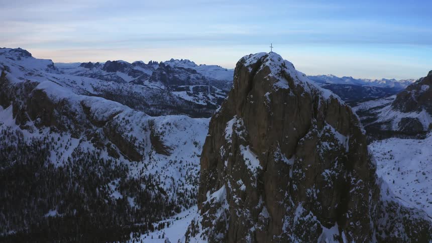 An aerial view of a mountain with snow on the top of it