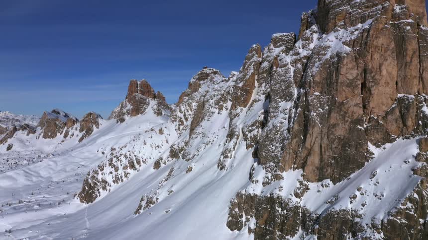 Aerial view of snowy high mountains against the blue sky