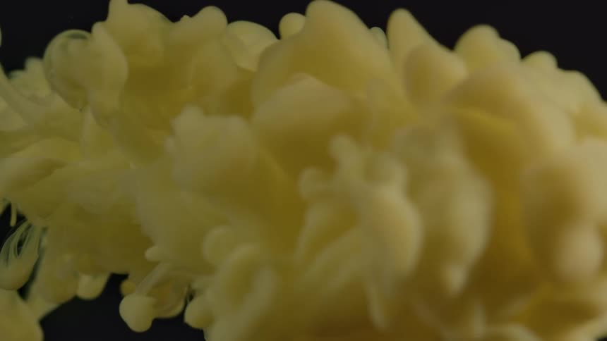 The yellow liquid shoots through the water