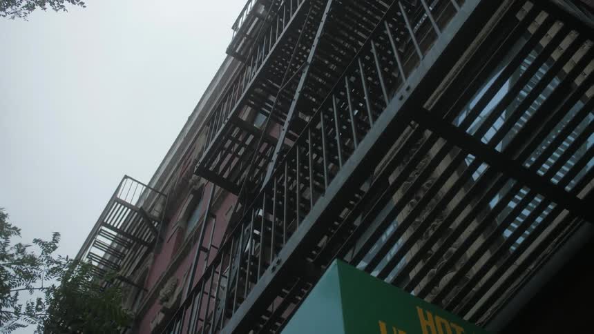 A fire escape goes up the height of a building in the city