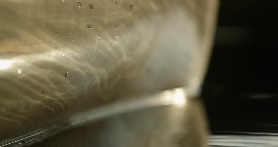 Water reflects off a gold metal object in the river