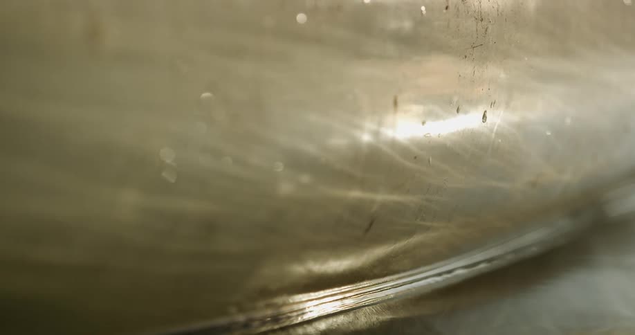 Sunlight reflected on the side of a boat floating on a lake at morning