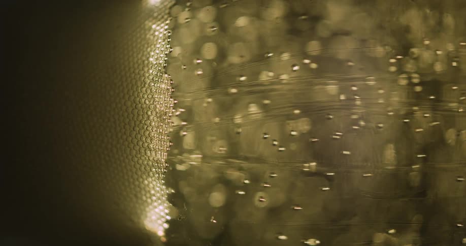 A close up of greenyellow dots flying into each other
