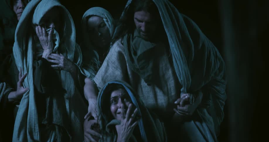 A woman is begging as a man holds her hand