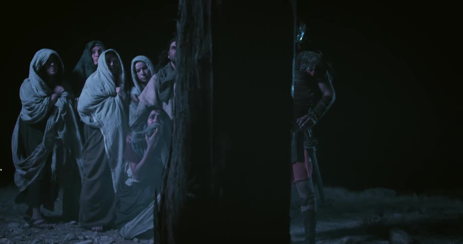 A roman soldier and men and woman looking at a cross
