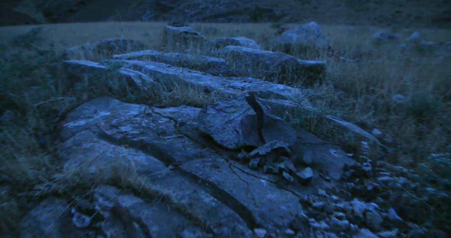 Special effects shot of a boulder on a field breaking up during an earthquake