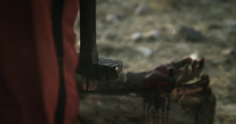 Panning shot revealing a bloody hand