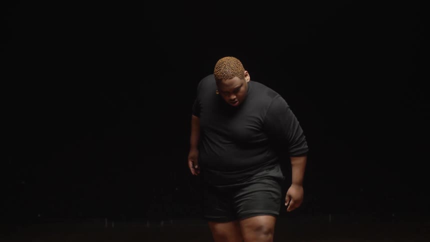 A man walks forward and begins his performance