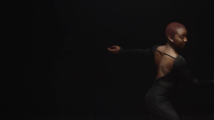 A black woman dances on a stage