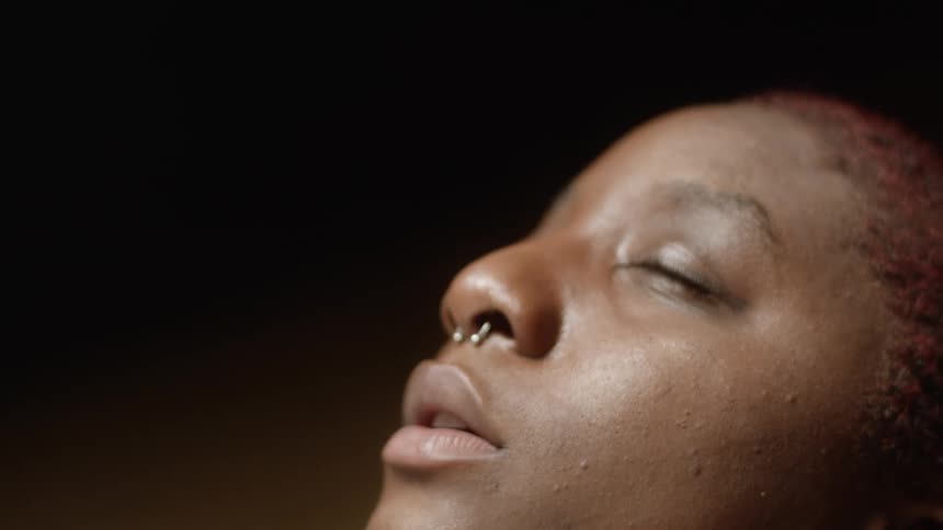 A woman is rubbing her head