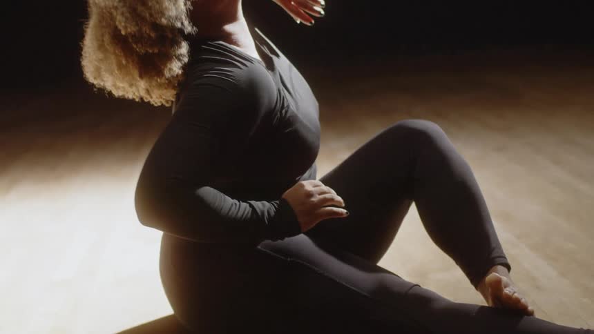 A woman dancing in a dark room