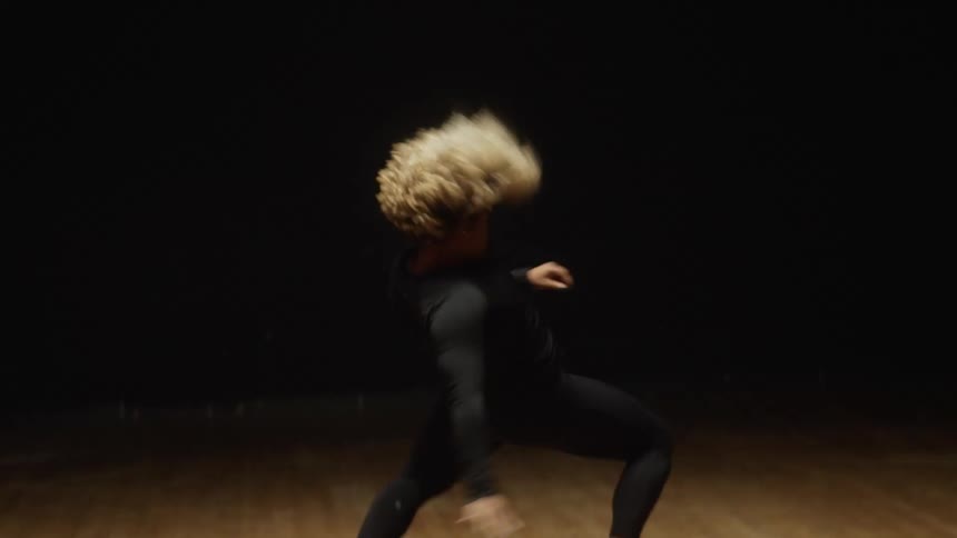 A woman is dancing and jumping all over