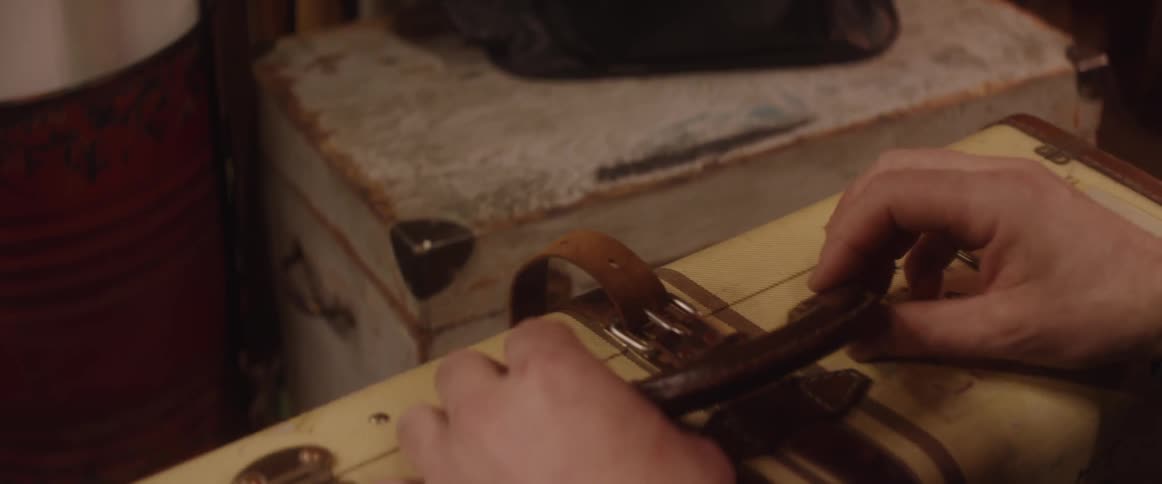 A person handles the handle of a suitcase
