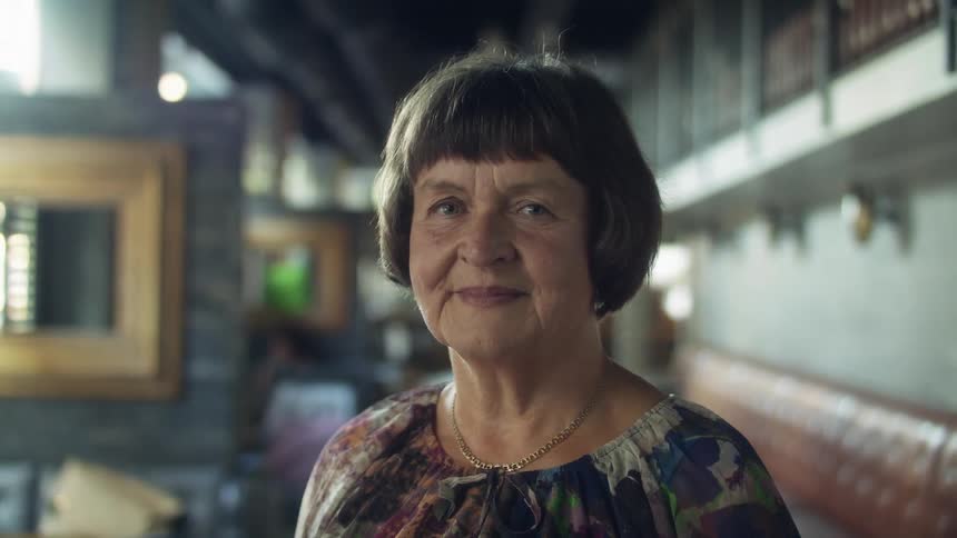A woman standing and smiling